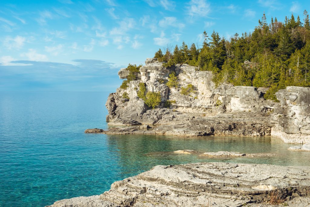 The limestone cliffside of Halfway Rock Point in Bruce Peninsula National Park, Ontario, Canada on a sunny day.